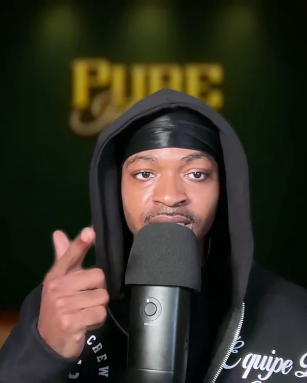 David Logan speaking into his podcast microphone